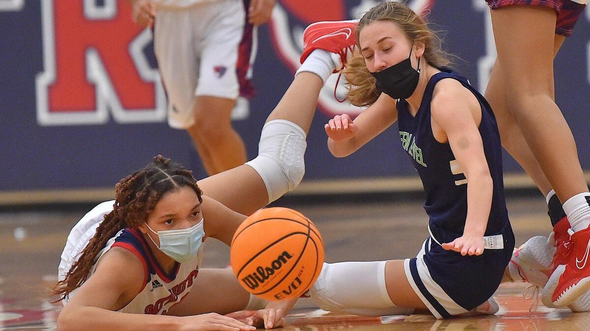 Apex Friendship’s Lia Anderson (23) and Green Level’s Maria Savvun (1) scramble for the loose ball during the second half. The Apex Friendship Patriots and the Green Level Gators met in a conference basketball game in Apex, NC on January 18, 2022.