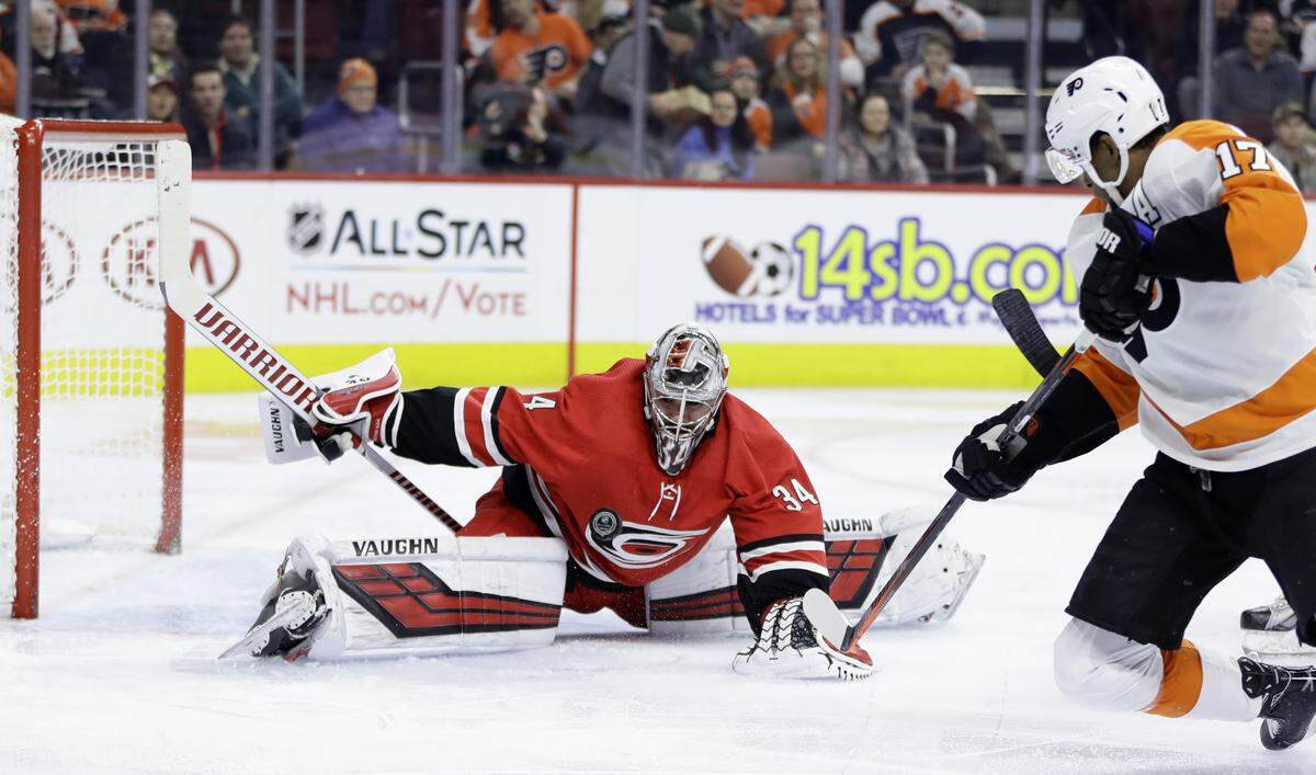 Carolina Hurricanes’ Petr Mrazek, left, blocks a shot by Philadelphia Flyers’ Wayne Simmonds during the second period of an NHL hockey game Thursday, Jan. 3, 2019, in Philadelphia.