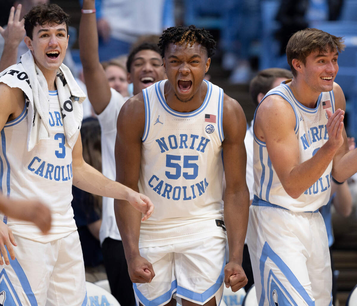 North Carolina’s Cormac Ryan (3), Harrison Ingram (55) and Paxson Wojcik (8) relish in breaking the century mark against Syracuse on Saturday, January 13, 204 at the Smith Center in Chapel Hill, N.C.
