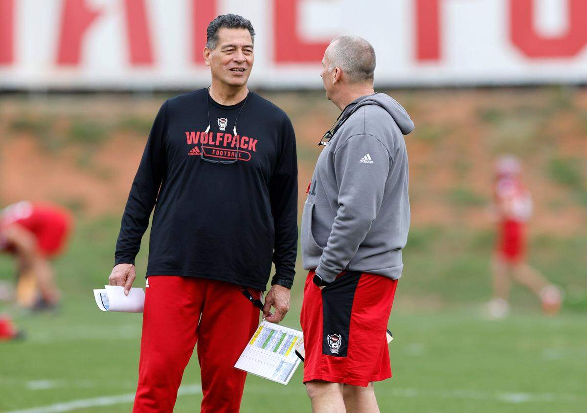 N.C. State offensive coordinator Robert Anae talks with head coach Dave Doeren during the Wolfpack’s first spring practice in Raleigh, N.C., Wednesday, March 1, 2023.