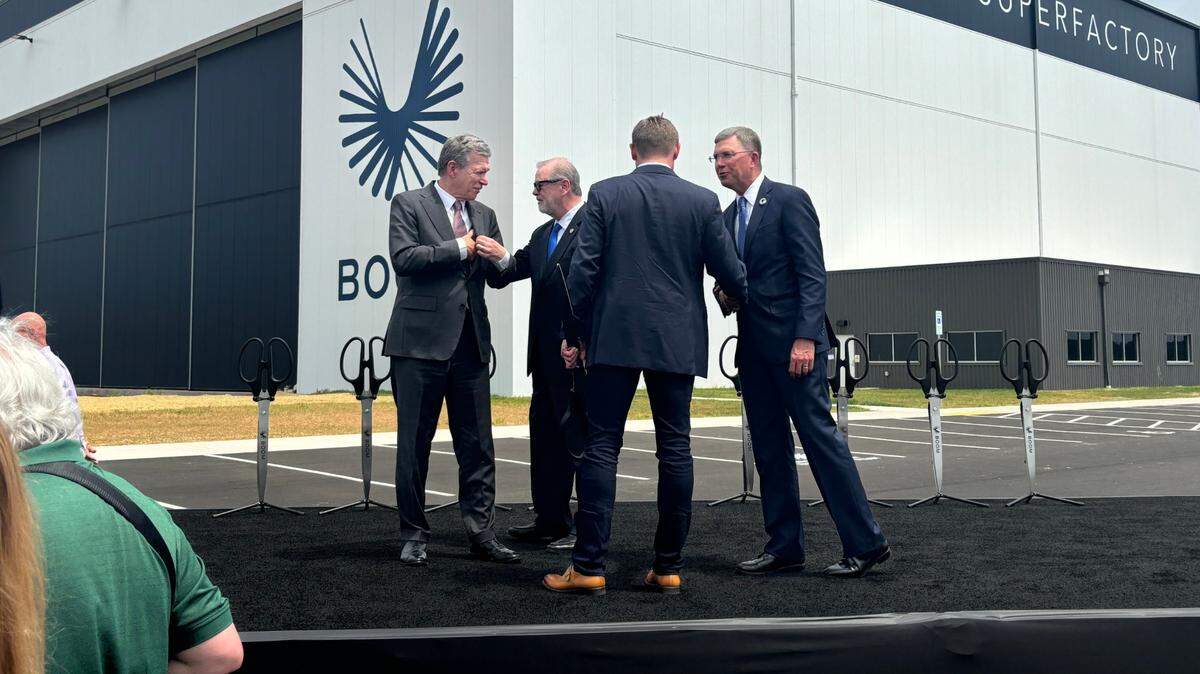 Gov. Roy Cooper (left) greets North Carolina Senate President Phil Berger after they helped cut the ceremonial ribbon on Boom Supersonic’s jet factory at the Piedmont Triad International Airport in Greensboro on June 17, 2024.
