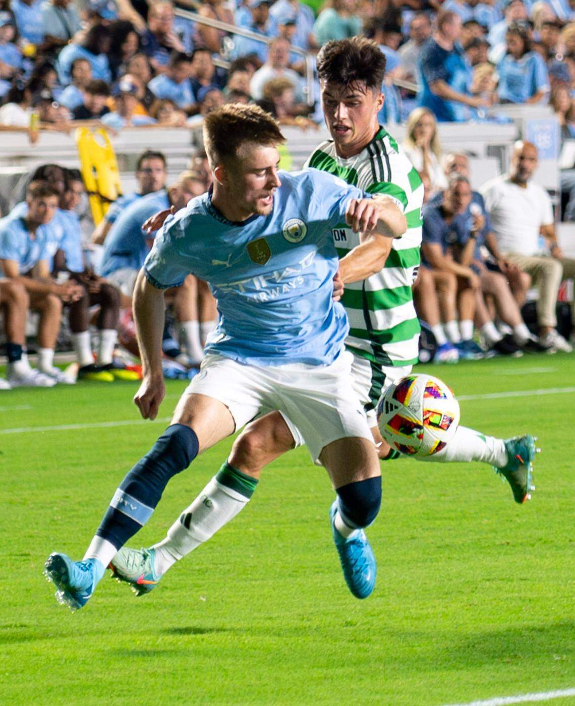 Manchester City midfielder Ben Knight (96) and Celtic FC defender Gustaf Lagerbielke (4) attempt to gain possession of the ball during the Celtic FC vs Manchester City at Kenan Stadium in Chapel Hill on Tuesday, July 23, 2024. Celtic FC won 4-3.