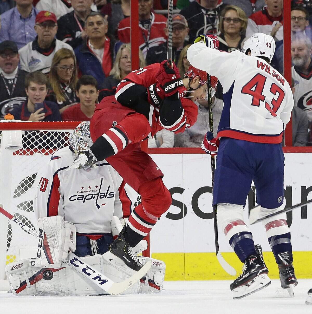 Carolina Hurricanes’ Nino Niederreiter (21) tries to score on Washington Capitals goalie Braden Holtby as Capitals’ Tom Wilson (43) defends during the first period of an NHL hockey game in Raleigh, N.C., Thursday, March 28, 2019.