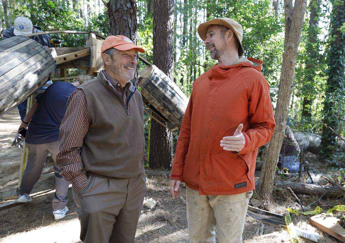 Thomas Dambo, right, talks with Carlton Midyette  at Dix Park in Raleigh, N.C. Thursday, Oct. 23, 2025. Five larger than life Thomas Dambo trolls are being installed at Dix using recycled wood, bourbon barrels, a one-mile long old fence and 75,000 screws.