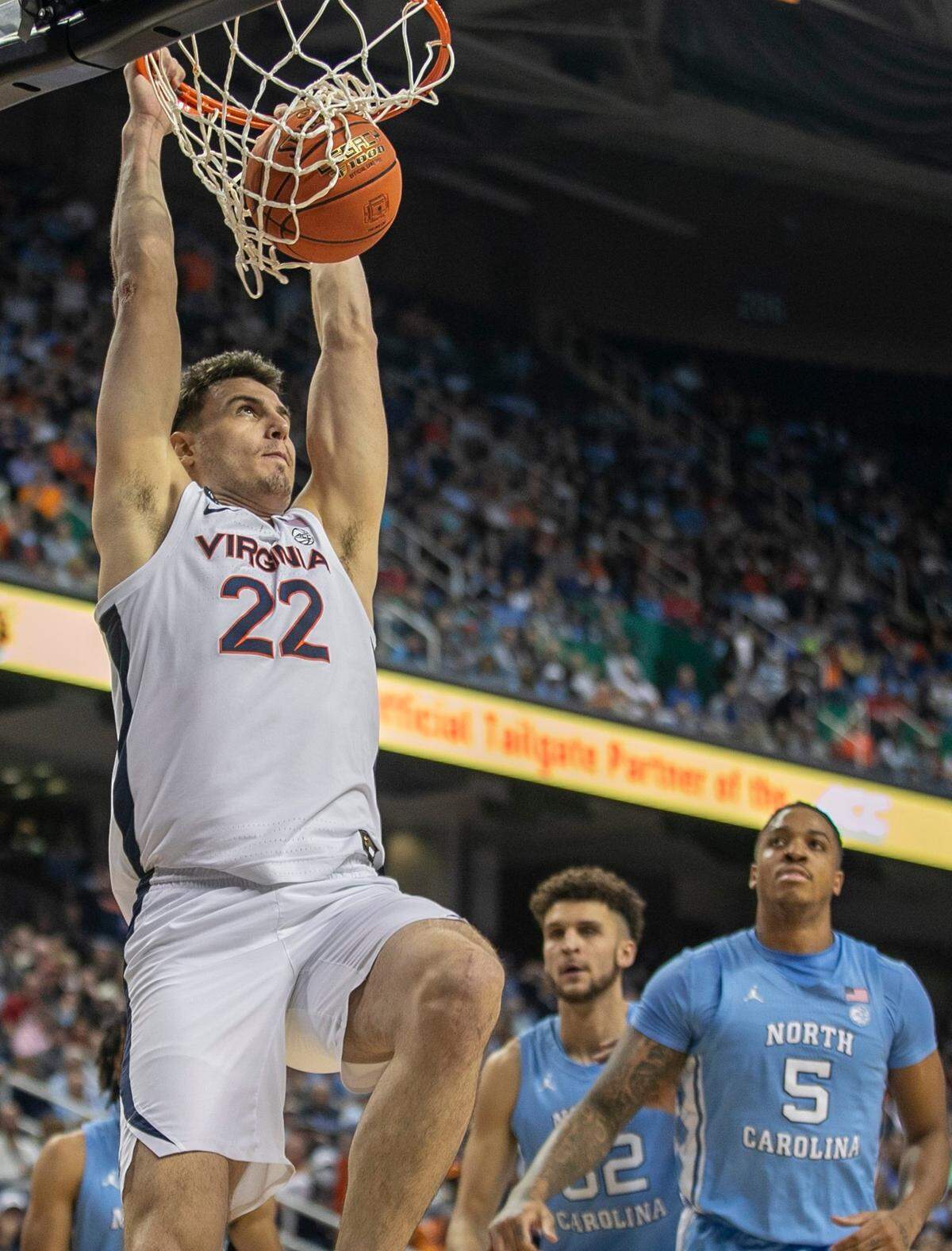 Virginia’s Francisco Caffaro (22) breaks to the basket for a dunk against North Carolina’s Armando Bacot (5) in the first half during the third round of the ACC Tournament on Thursday, March 9, 2023 at the Greensboro Coliseum in Greensboro, N.C.
