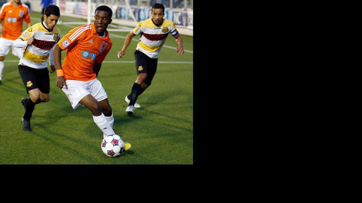 RailHawk‘' Tiyiselani Shipalane, center, dribbles with the ball away from defensive pressure from Strikers' Martin Nuñez, left, and Ivan Guerrero during the Carolina RailHawks' season-opening home game against the Ft. Lauderdale Strikers at WakeMed Soccer Park in Cary on Saturday, April 19, 2014.

