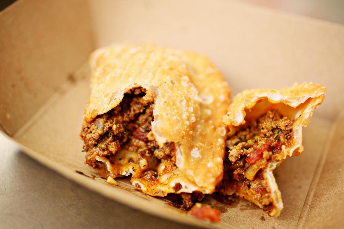 The Fuzzy empanada from Fuzzy’s Empanadas food truck contains seasoned ground beef, cilantro, red and yellow bell peppers, tomatoes and olives.