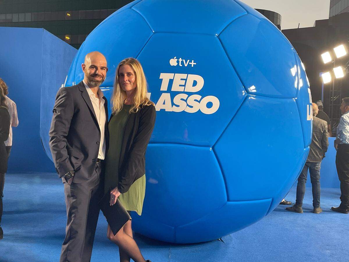 Kip Kroeger, a supervising producer for the hit Apple TV+ series Ted Lasso, with his wife Tara Olsen on the show’s set.