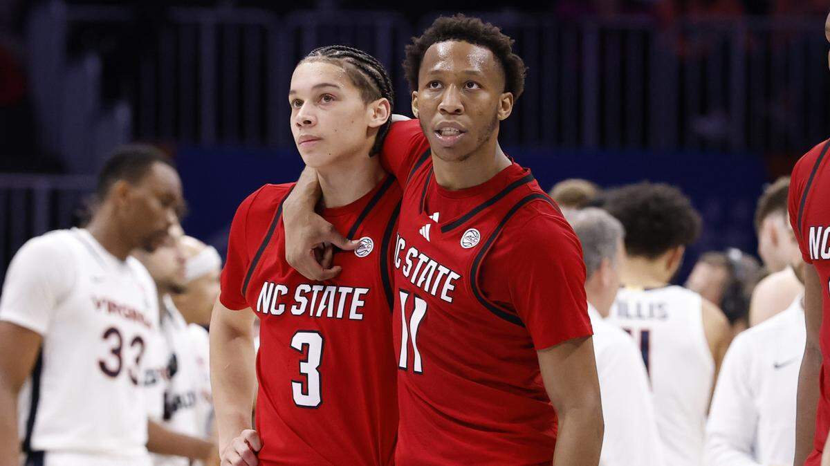 N.C. State's Quadir Copeland (11) and N.C. State's Matt Able (3) walk back to the bench after a timeout late in the second half of Virginia’s 81-74 victory over N.C. State in the quarterfinals of the 2026 ACC Men’s Basketball Tournament at the Spectrum Center in Charlotte, N.C., Thursday, March 12, 2026.