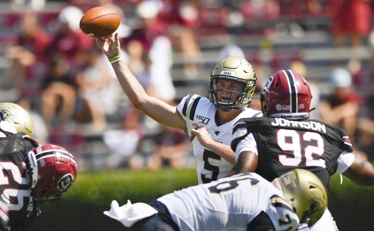 In this 2019 file photo, Charleston Southern quarterback Ross Malmgren (5) gets a pass of as South Carolina defensive lineman Tyreek Johnson (92) defends during a game in Sept. 2019, in Columbia, S.C.