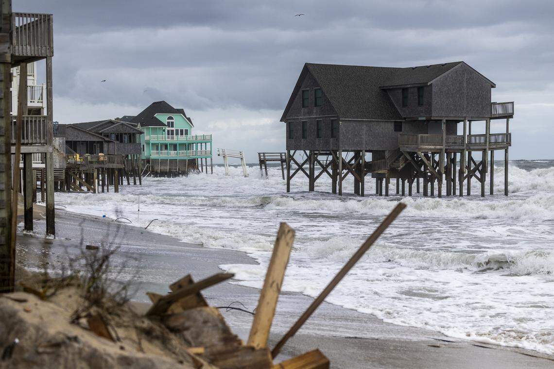 Rough surf threatens beach homes during high tide Friday morning, Oct. 10, 2025, in Buxton as a nor’easter approaches the North Carolina coast. 