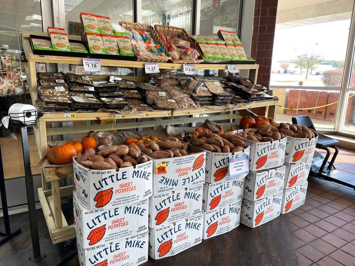 Local Johnston County-grown sweet potatoes are on display at Carlie C’s IGA grocery store in Raleigh the week before Thanksgiving, Nov. 16, 2022.