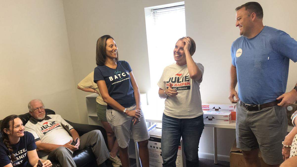 From left, activists Shannon Norland and John Yach listen as North Carolina legislative candidates Sydney Batch, Julie von Haefen and Sam Searcy talk to volunteers on July 21, 2018, at Wake County Democratic Party headquarters in Apex, N.C., before they go out to knock on the doors of registered voters.