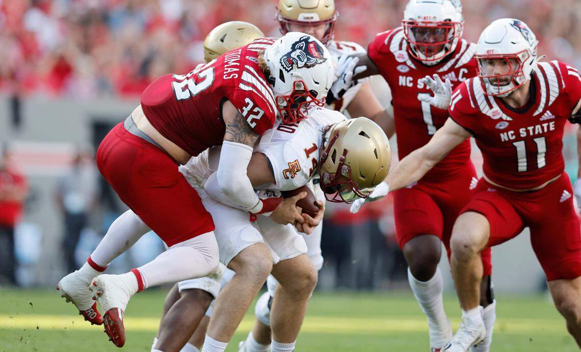 N.C. State linebacker Drake Thomas (32) sacks Boston College quarterback Emmett Morehead (14) during the first half of N.C. State’s game against Boston College at Carter-Finley Stadium in Raleigh, N.C., Saturday, Nov. 12, 2022.
