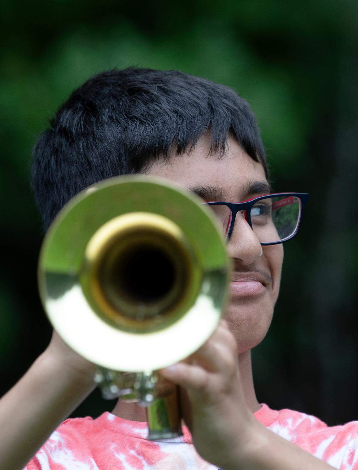 Freshman Anirudh Mohan grins while holding a trumpet during the first day of marching band camp at Jordan High School on Monday, July 22, 2024, in Durham, N.C.