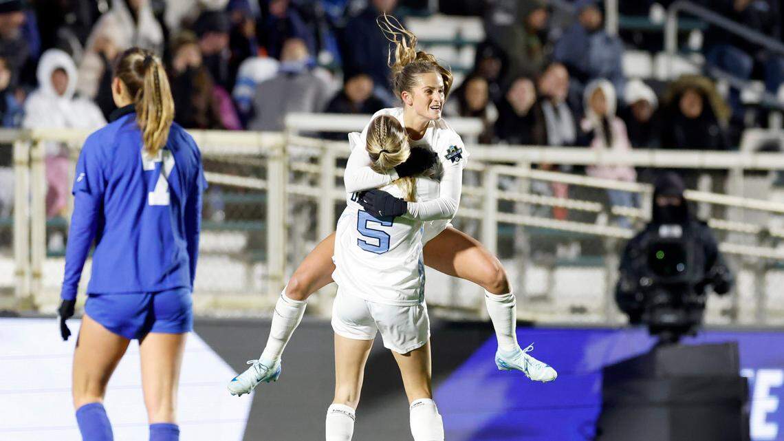 North Carolina’s Kate Faasse (13) jumps into the arms of Maddie Dahlien (5) after Faasse scored on a penalty kick during the first half of UNC’s game against Duke in the semifinals of the 2024 Women’s College Cup at WakeMed Soccer Park in Cary, N.C., Friday, Dec. 6, 2024.
