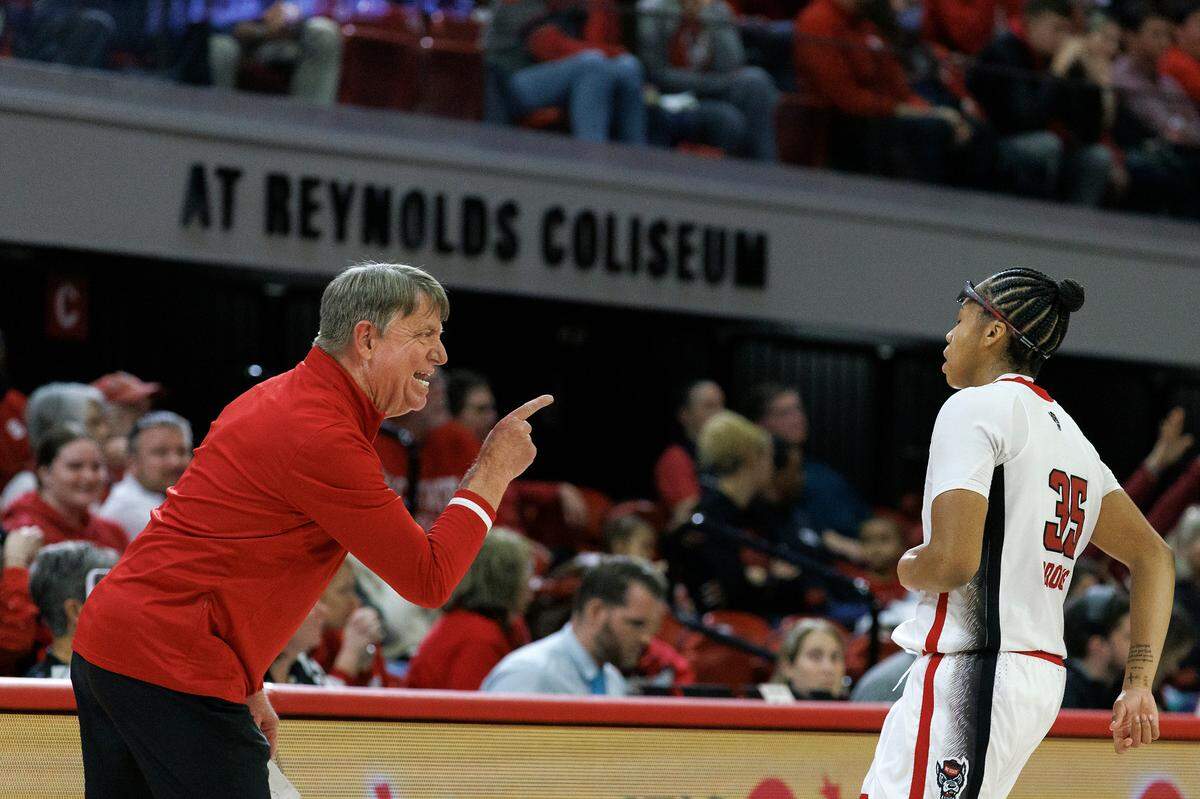 N.C. State head coach Wes Moore speaks with Zoe Brooks during the second half of the Wolfpack’s 88-80 win over Florida State on Thursday, Jan. 4, 2023, at Reynolds Coliseum in Raleigh, N.C.