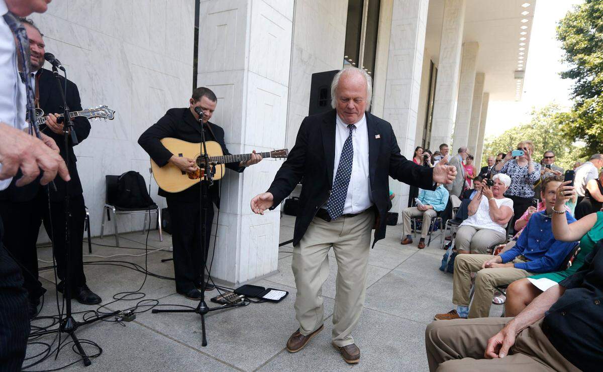 Former Rep. Joe Sam Queen dances as Balsam Range, the 2014 IBMA Entertainer of the Year, perform outside the State Legislative Building in Raleigh on June 10, 2015.