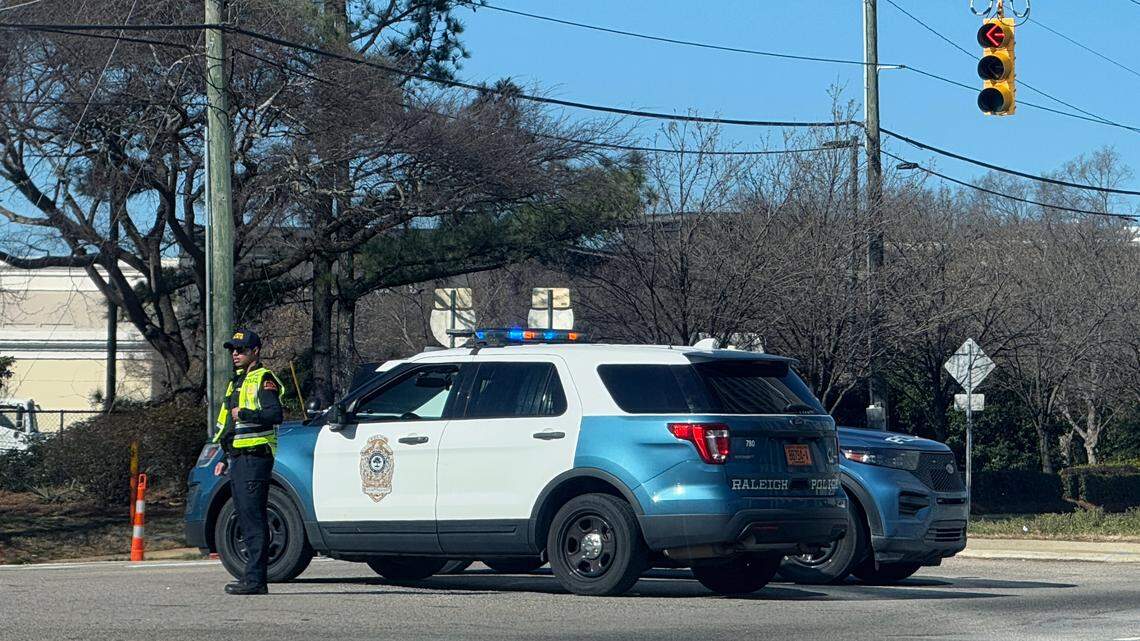 Raleigh Police officers block one of the entrances to North Hills after a shooting Friday morning.