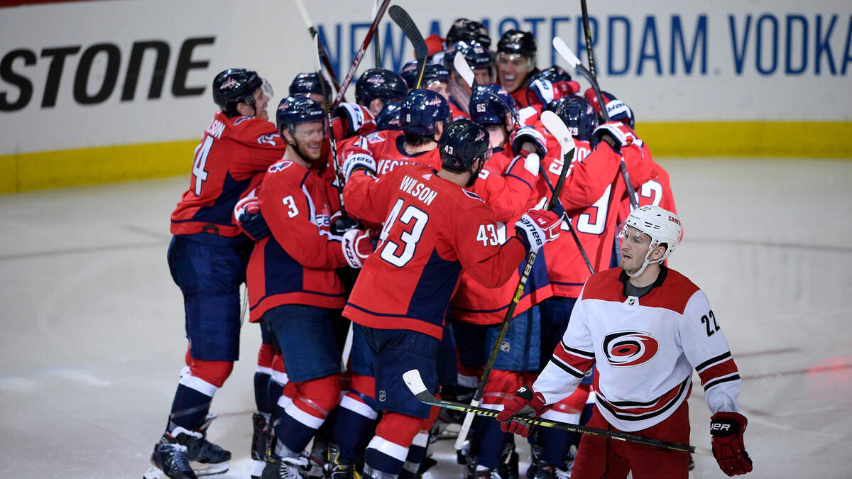 Carolina Hurricanes defenseman Brett Pesce (22) skates by as the Washington Capitals celebrate after Game 2 of an NHL hockey first-round playoff series, Saturday, April 13, 2019, in Washington. The Capitals won 4-3 in overtime. (AP Photo/Nick Wass)