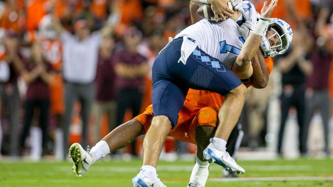 Virginia Tech’s TyJuan Garbutt (45) sacks North Carolina quarterback Sam Howell (7) in the fourth quarter on Friday, September 3, 2021 at Lane Stadium in Blacksburg, Va. Howell was sacked six times by the Virginia Tech defense and threw three interceptions.