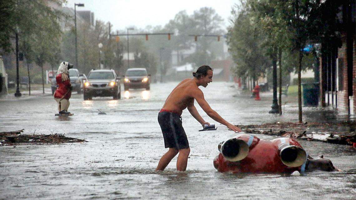 Teddie Davis goes to check on one of the town’s signature bears that was toppled by Hurricane Florence in downtown New Bern, N.C., on Friday, Sept. 14, 2018. Another one of the bears ended up in the middle of the street in the background. 