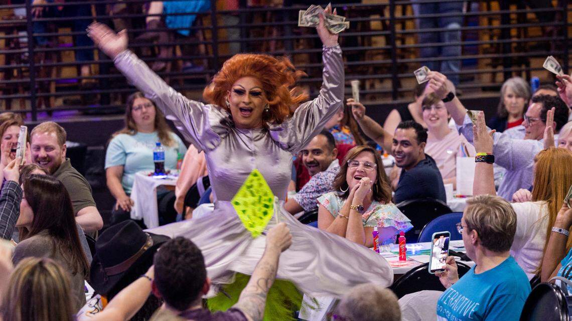 A drag performer collects dollar bills from the audience during North Carolina’s oldest running drag show, Green Queen Bingo, which dates to 2004 and regularly fills Piedmont Hall in Greensboro.