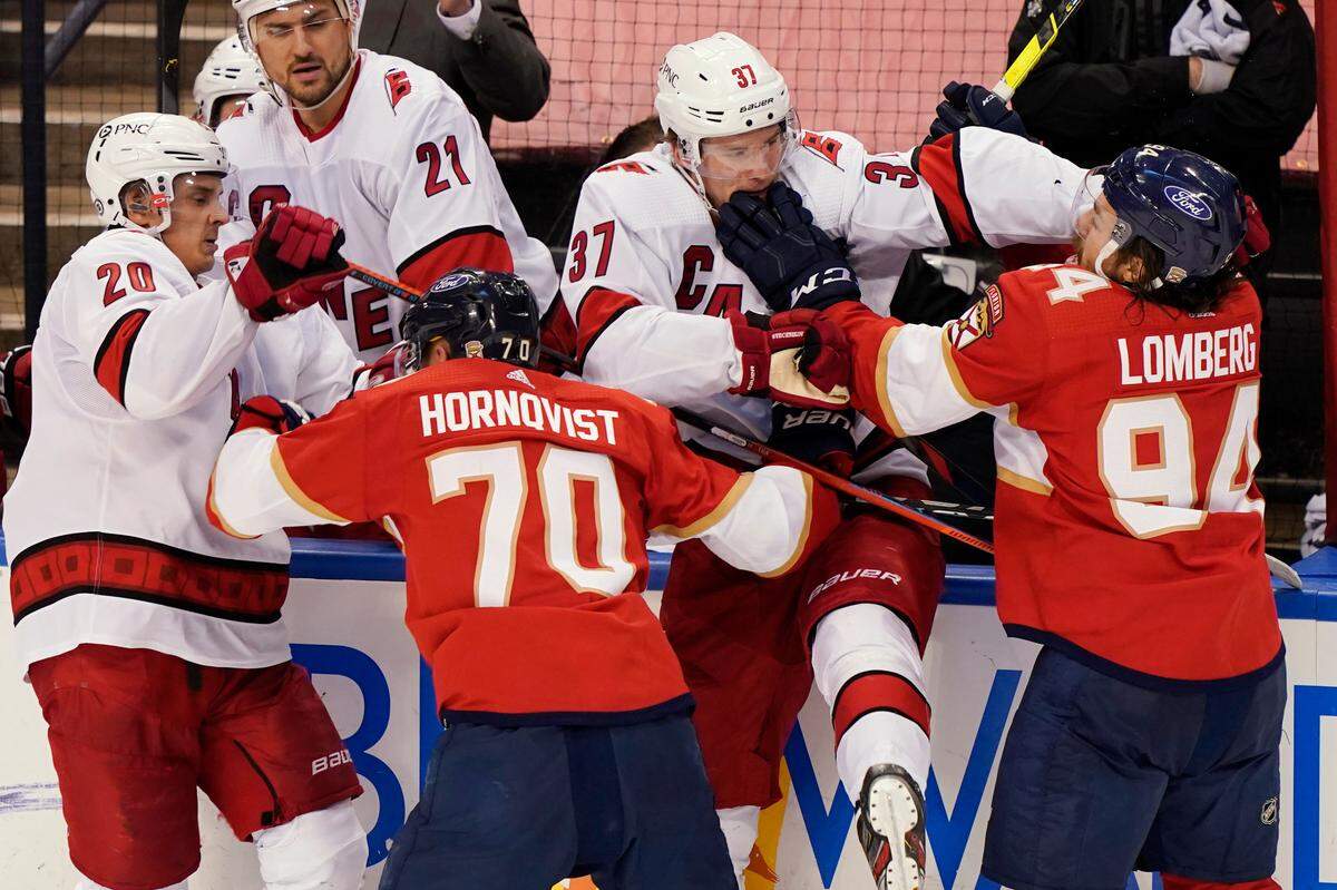 Carolina Hurricanes right wings Sebastian Aho (20) and Andrei Svechnikov (37) scuffle with Florida Panthers right wing Patric Hornqvist (70) and left wing Ryan Lomberg (94) during the third period of an NHL hockey game, Thursday, April 22, 2021, in Sunrise, Fla. (AP Photo/Marta Lavandier)