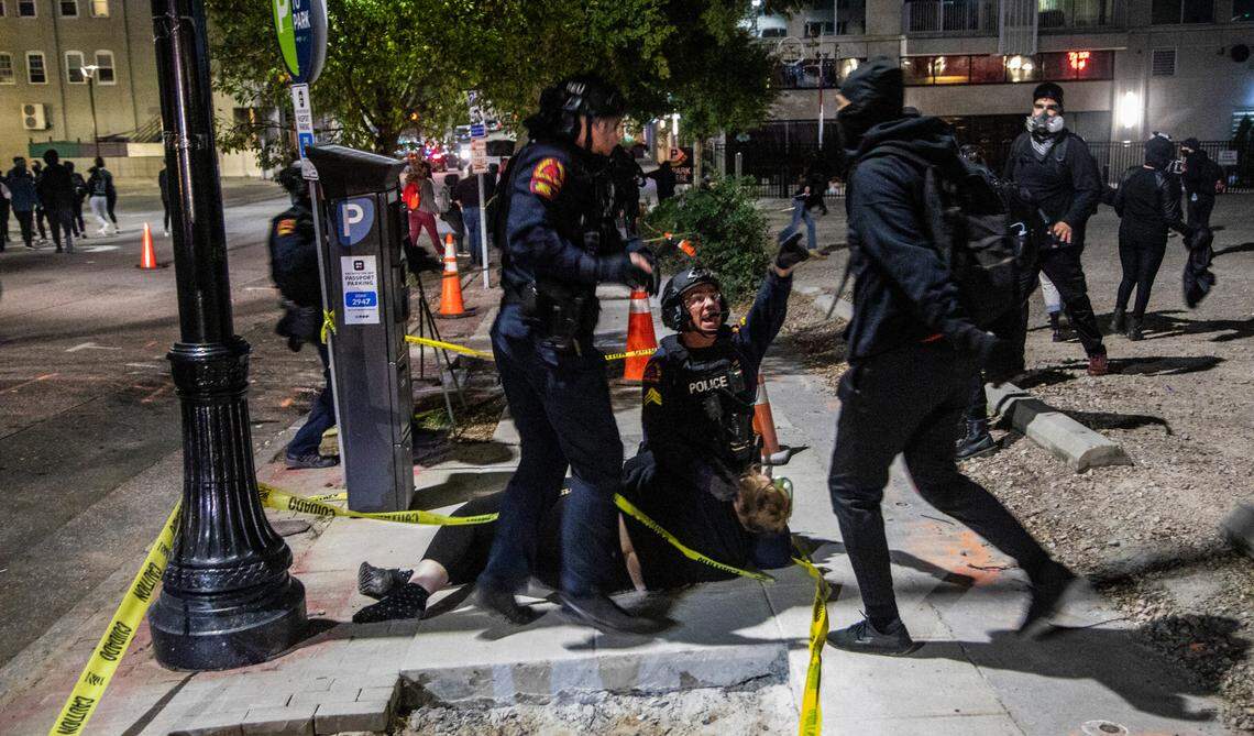 A protester is arrested as about a hundred demonstrators marched around downtown Raleigh after polls closed Tuesday, Nov. 3, 2020. Raleigh police made about a half dozen arrests.
