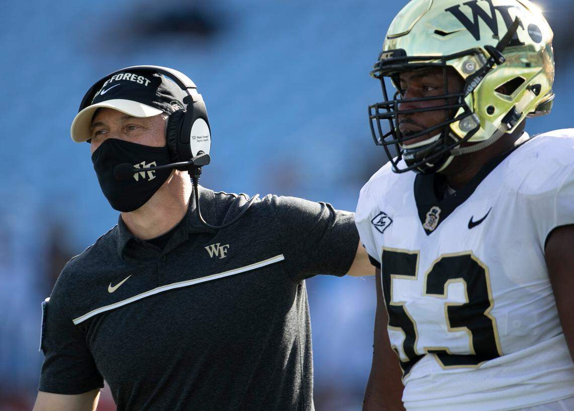 Wake Forest head coach Dave Clawson embraces lineman Je’Vionte’ Nash (53) after a score in the second quarter against North Carolina at Kenan Stadium on Saturday, November 14, 2020 in Chapel Hill, N.C.