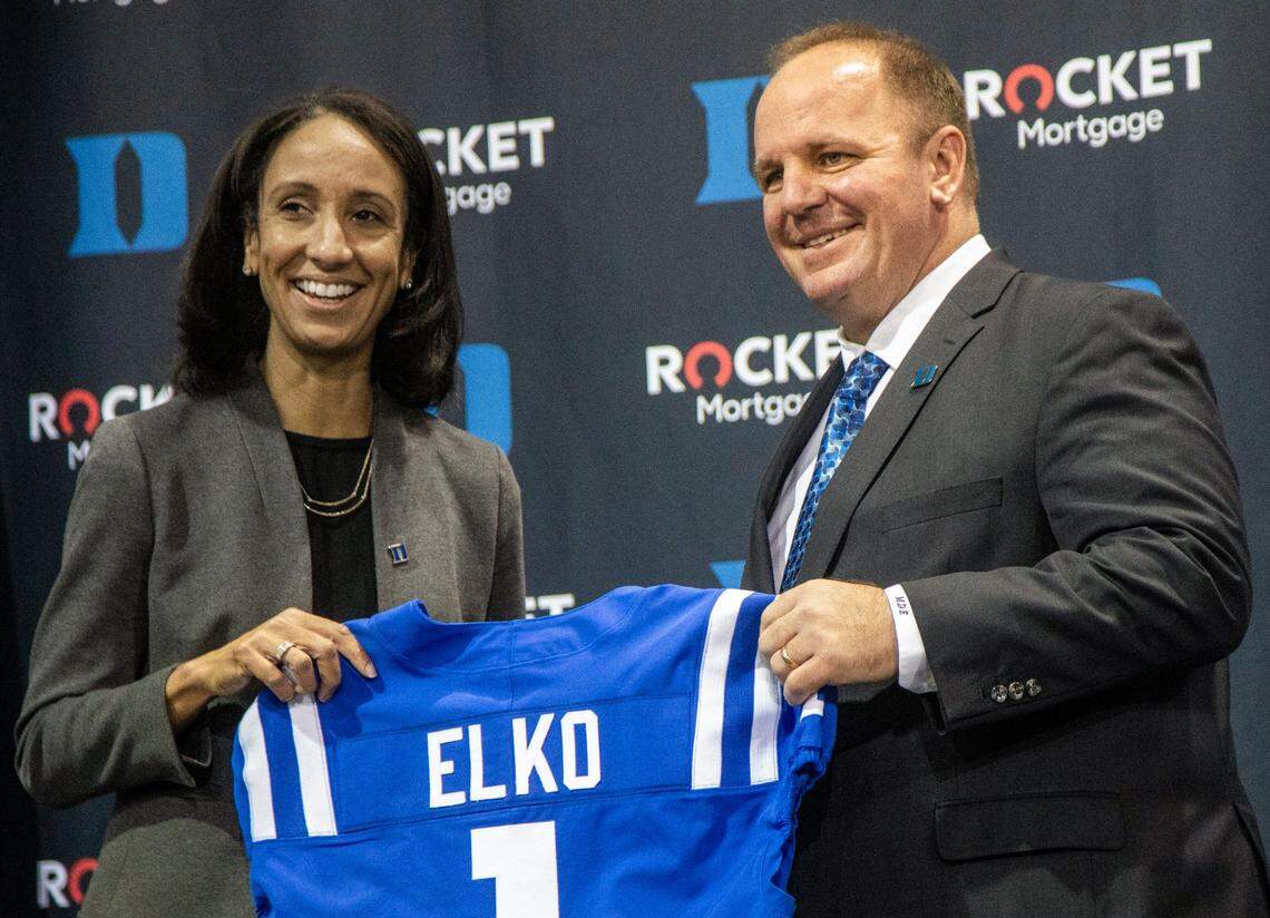 Vice President and Director of Athletics Nina King, left, andHead Football Coach Mike Elko hold up a Jersey with Elkoís name after he was introduced as Dukeís head football coach during a press conference at Pascal Field House in Durham, Monday, Dec. 13, 2021.
