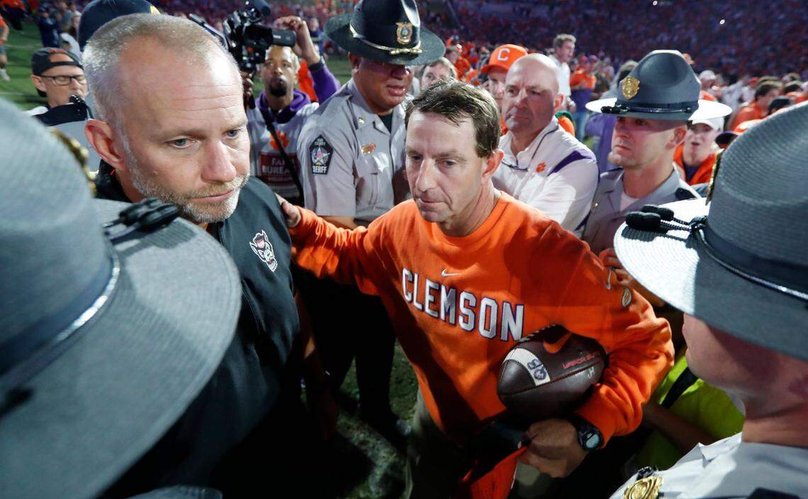 Clemson head coach Dabo Swinney talks with N.C. State head coach Dave Doeren after Clemson’s 30-20 victory over N.C. State at Memorial Stadium in Clemson, S.C., Saturday, Oct. 1, 2022.