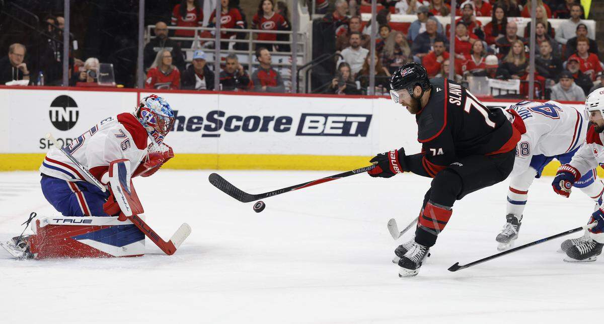 Carolina's Jaccob Slavin (74) can’t get the puck past Montréal's Jakub Dobes (75) during the first period of the Hurricanes’ game against the Canadiens in game two of the Eastern Conference Finals at the Lenovo Center in Raleigh, N.C., Saturday, May 23, 2026.