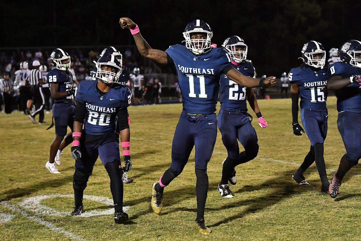Southeast Raleigh defensive end Keysaun Eleazer (11) celebrates with teammates after making the interception against Clayton during the second half. The Southeast Raleigh Bulldogs and the Clayton Comets met in a non-conference football game in Raleigh, N.C. October 3, 2025