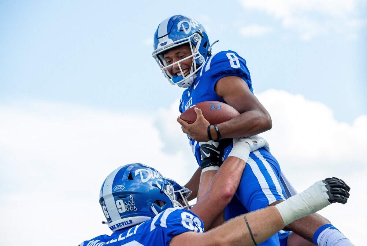 Duke’s Jordan Moore (8) is lifted into the air by teammates after carrying the ball for a touchdown during the first half of and NCAA football game in Durham, N.C., Saturday, September 18, 2021.