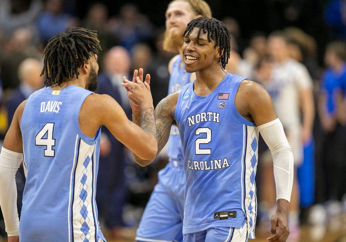 North Carolina’s Caleb Love (2) and R.J. Davis (4) react as they secure the Tar Heels’ 73-66 victory over UCLA on Friday, March 25, 2022 during the NCAA East Regional semi-final at Wells Fargo Center in Philadelphia, Pa.