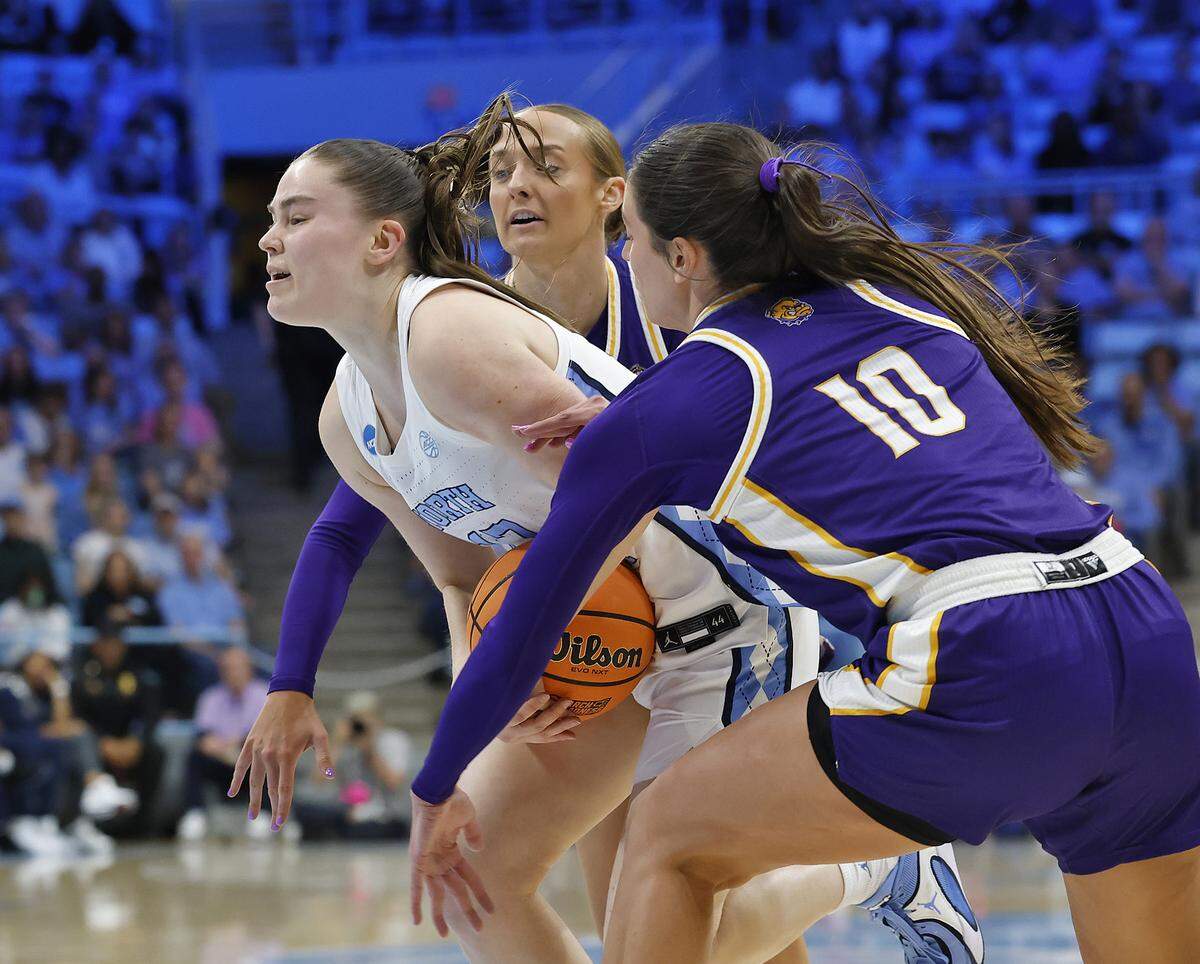 North Carolina’s Elina Aarnisalo drives through Western Illinois’ Addi Brownfield and Mallory Shetley during the first half of the Tar Heels’ 82-51 first-round NCAA Tournament win on Friday, March 20, 2026, at Carmichael Arena in Chapel Hill, N.C.