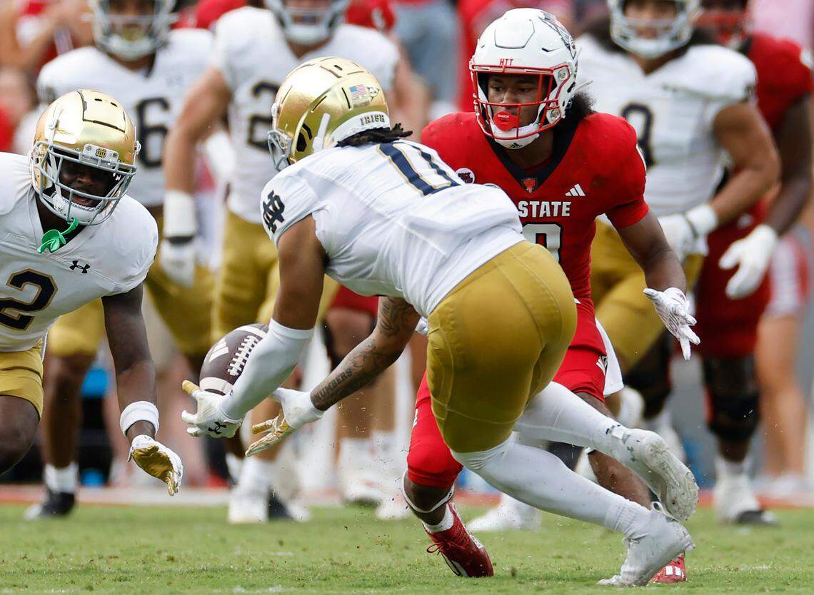 Notre Dame safety Xavier Watts (0) intercepts the ball intended for N.C. State wide receiver KC Concepcion (10) during the second half of Notre Dame’s 45-24 victory over N.C. State at Carter-Finley Stadium in Raleigh, N.C., Saturday, Sept. 9, 2023.