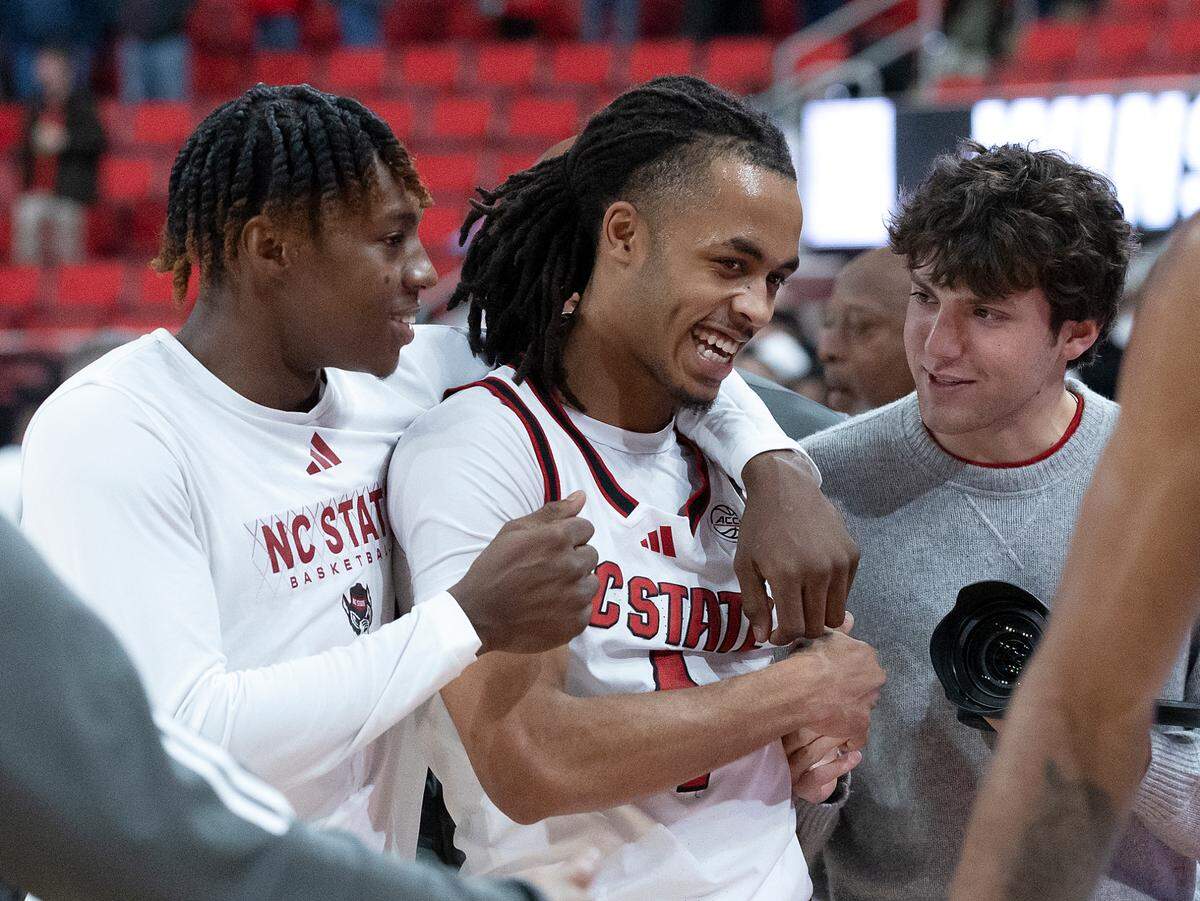 N.C. State’s Trey Parker and Breon Pass smile as they walk off the court following the Wolfpack’s 66-65 win over Notre Dame on Wednesday, Jan. 8, 2025, at Lenovo Center in Raleigh, N.C.