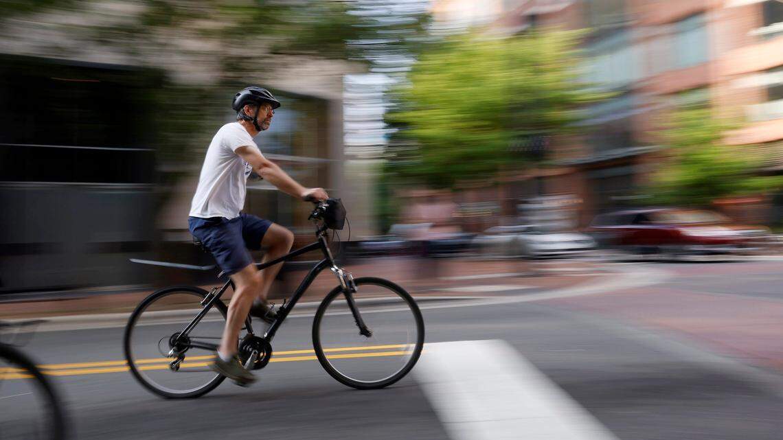 People ride bikes through downtown Durham, N.C. during the Ride of Silence on Wednesday, May 17, 2023. The event remembers those who were killed or injured while biking.