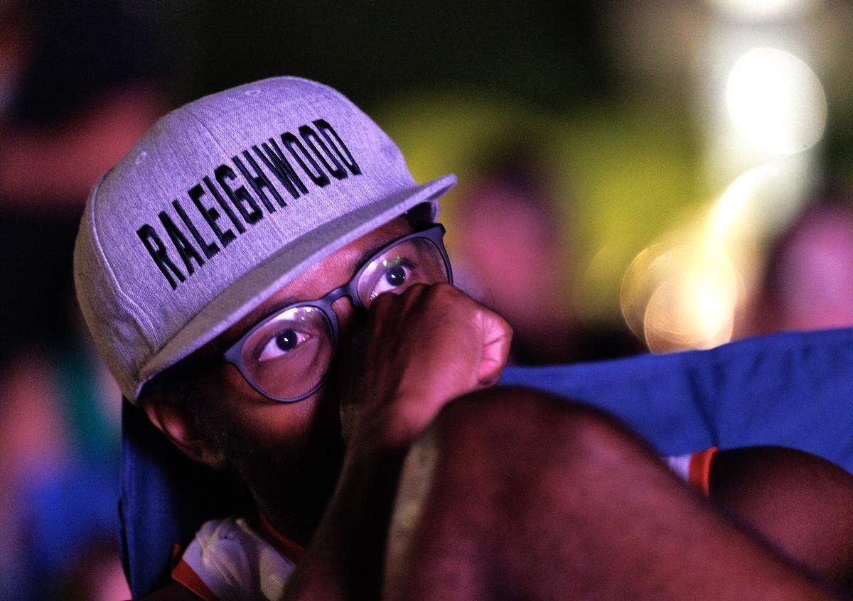 A person watches the second period of Game 2 of the Stanley Cup Final between the Carolina Hurricanes and the Vegas Golden Knights during a watch party in Moore Square on Thursday, June 4, 2026, in Raleigh, N.C.