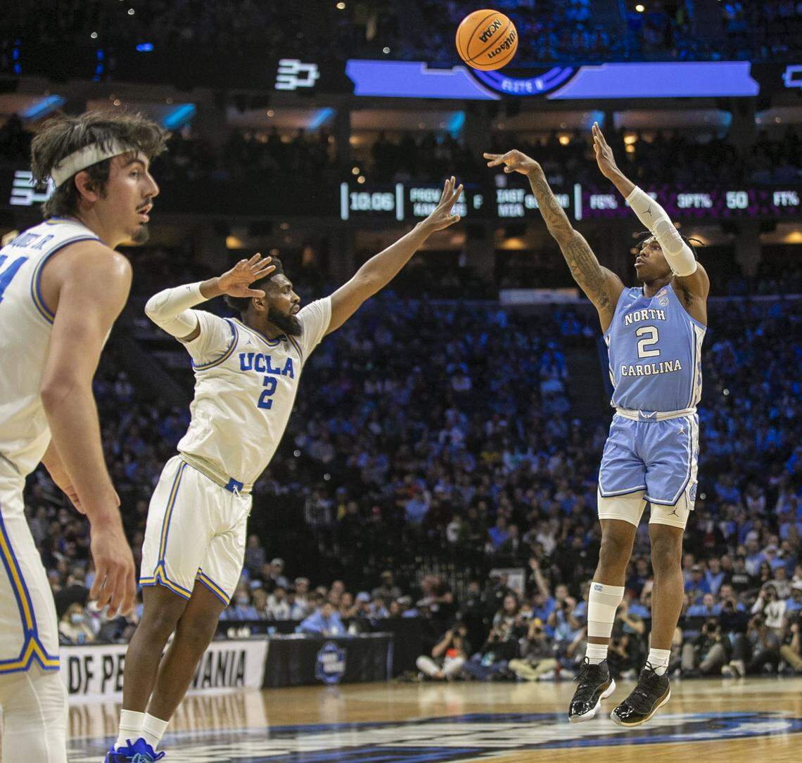 North Carolina’s Caleb Love (2) makes his only basket of the first half against UCLA’s Cody Riley (2) on Friday, March 25, 2022 during the NCAA East Regional semi-final at Wells Fargo Center in Philadelphia, Pa. Love would go on to score 27 in the second half.