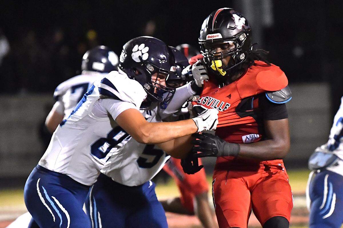 Rolesville’s defensive end Zavion Griffin-Haynes (9) engages with Millbrook defensive end Hayes Brawner (87) during the second half. The Rolesville Rams and the Millbrook Wildcats met in a football game in Raleigh. N.C. on October 11, 2024.