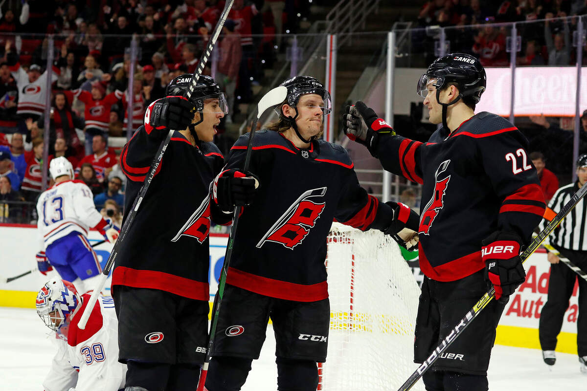 Carolina Hurricanes’ Erik Haula (56), center, is congratulated by teammates Brett Pesce (22) and Carolina Hurricanes’ Teuvo Teravainen (86), of Finland, during the second period of an NHL hockey game against the Montreal Canadiens in Raleigh, N.C., Tuesday, Dec. 31, 2019. (AP Photo/Karl B DeBlaker)