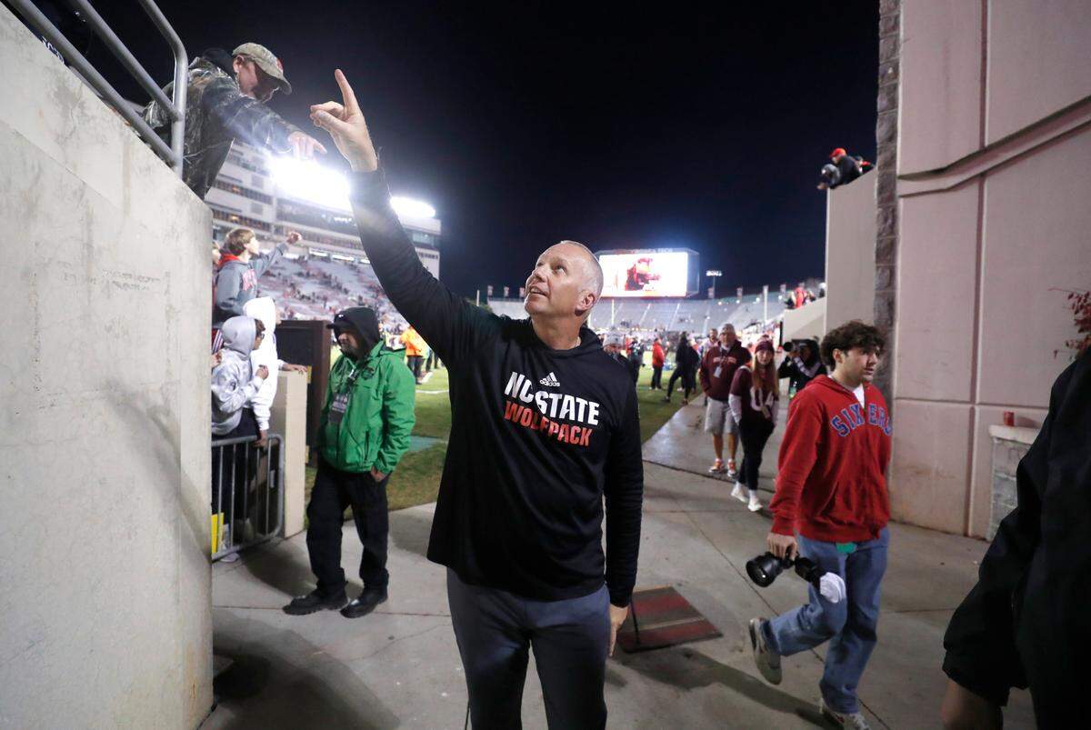 N.C. State head coach Dave Doeren acknowledges the crowd as he leaves the field after N.C. State’s 35-28 victory over Virginia Tech at Lane Stadium in Blacksburg, VA, Saturday, Nov. 18, 2023.