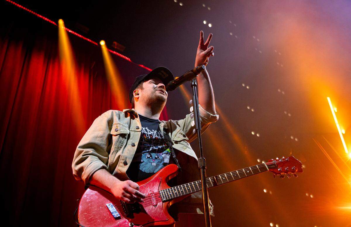Fall Out Boy’s Patrick Stump gestures to the crowd during their concert at Raleigh, N.C.’s PNC Arena, Tuesday night, March 19, 2024.