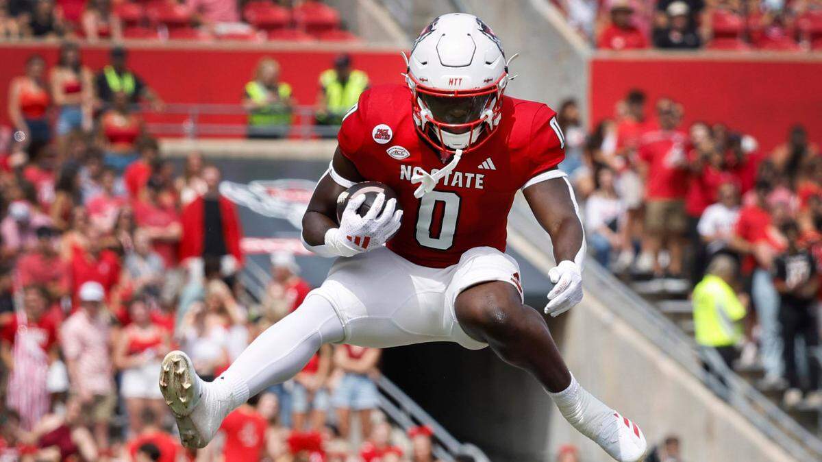 N.C. State running back Kendrick Raphael (0) hurdles over Louisiana Tech defensive back Demarcus Griffin-Taylor (8) during the first half of N.C. State’s game against LA Tech at Carter-Finley Stadium in Raleigh, N.C., Saturday, Sept. 14, 2024.