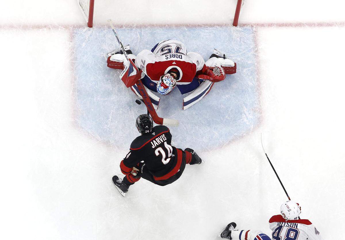 Montréal's Jakub Dobes (75) blocks the shot by Carolina's Seth Jarvis (24) during the Canadiens’ 6-2 victory over the Hurricanes in game one of the Eastern Conference Finals at the Lenovo Center Thursday, May, 21, 2026.