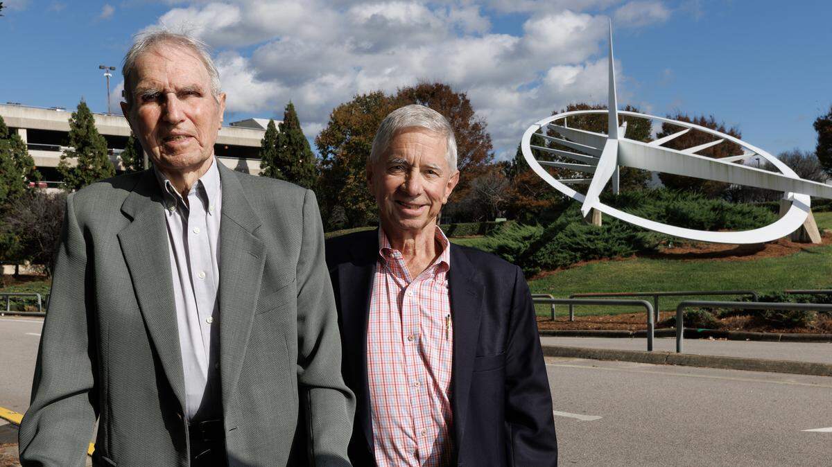 Ben Taylor and Thad Woodard pose for a portrait near the Triangle Icon sculpture at Raleigh-Durham International Airport on Thursday, Oct. 30, 2025. The two men were the driving force behind the creation of the monument, which commemorates the Wright Brothers’ first flight at Kitty Hawk.