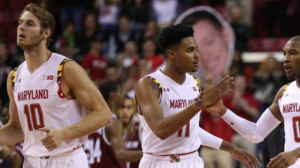 Rasheed Sulaimon #0 high-fives teammates Jared Nickens #11 of the Maryland Terrapins during a timeout against the Rider Broncs during the second half at Xfinity Center on November 20, 2015 in College Park, Maryland. The Maryland Terrapins won, 65-58. (Photo by Patrick Smith/Getty Images)